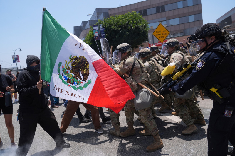 Los manifestantes se enfrentan a las autoridades en el centro de Los Ángeles, el domingo 8 de junio de 2025, después de protestas contra las redadas migratorias de la noche anterior.
