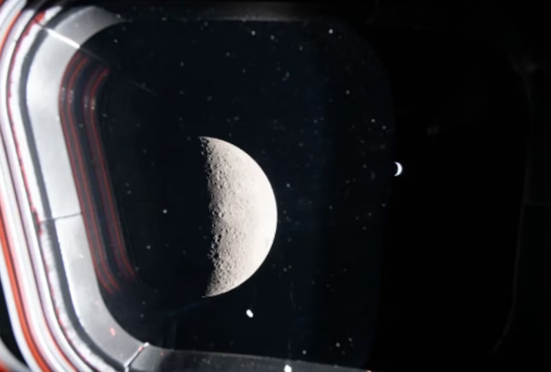 Desde la cara oculta de la Luna, los astronautas tomaron esta fotografía a través de una de las ventanas de la nave espacial Orion. Muestra una Luna creciente en primer plano, con una Tierra brillante pero pequeña al fondo. (OLLA)