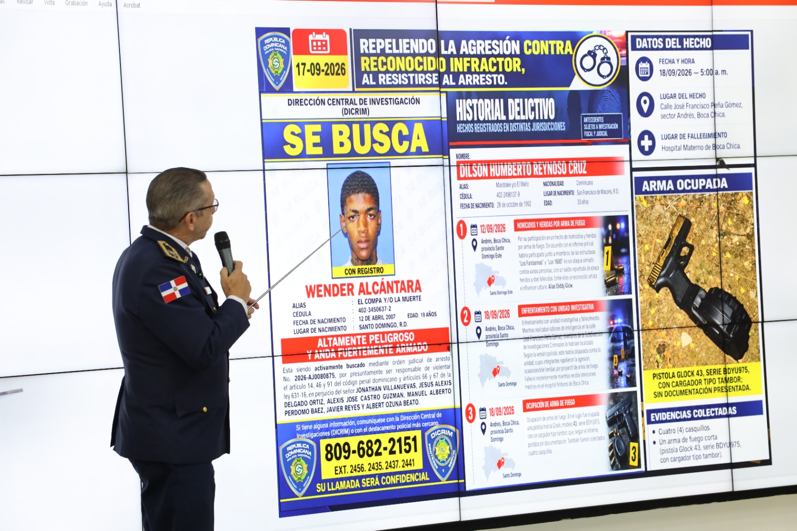 Oficial muestra cartel de búsqueda y detalles de presunto delincuente asesinado durante presentación policial en República Dominicana