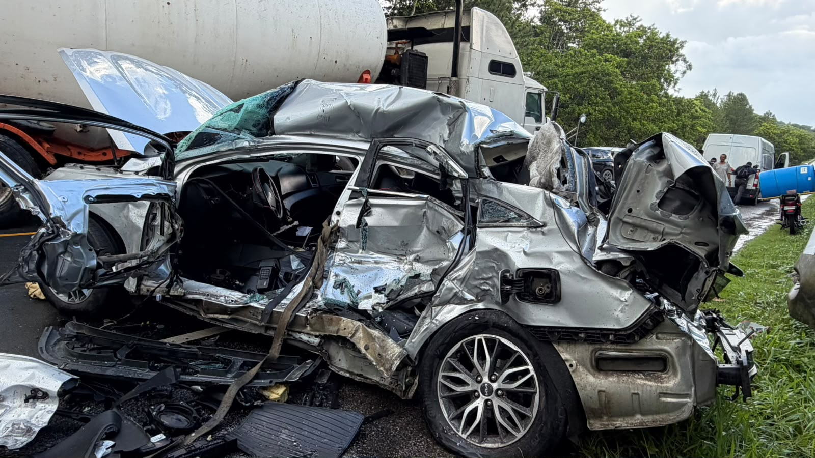 Auto gravemente destruido tras choque en la Carretera del Noreste que dejó dos heridos, entre ellos un agente de la DIGSETT