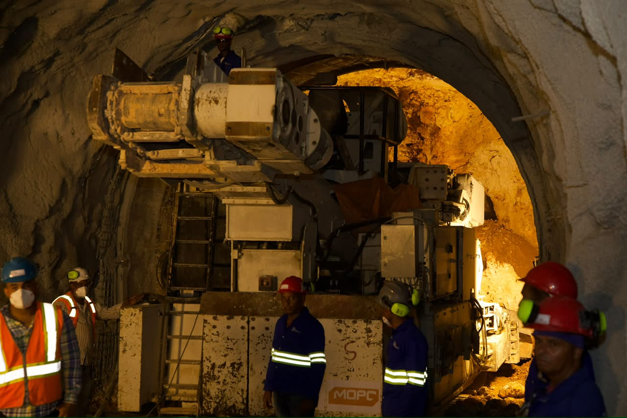 Trabajadores y maquinaria de perforación dentro de túnel de lluvia supervisado por Abinader en Avenida Luperón